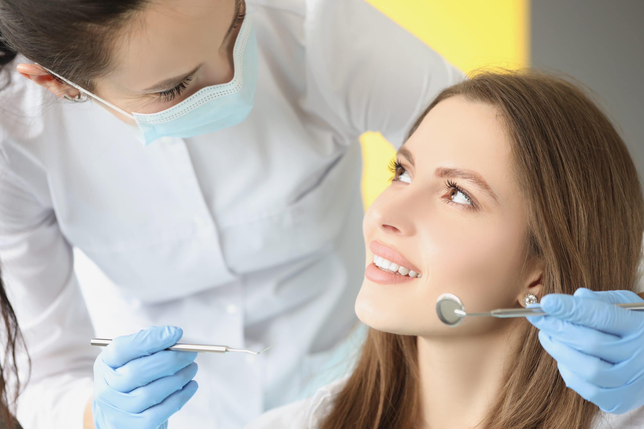 female in dentist chair, appointment in dental clinic